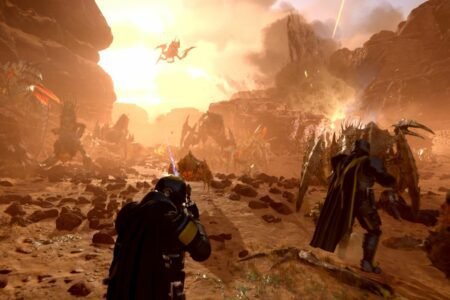 two players battling horde of aliens on an alien planet in Helldivers 2