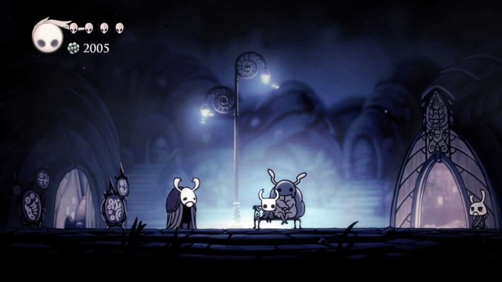 Does Hollow Knight Silksong Have Denuvo? | | GamesHorizon A screenshot of Hollow Knight sitting in Dirtmouth alongside other bugs in Hollow Knight