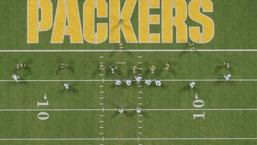 A red zone play unfolds in Madden NFL 26 as the Packers defense lines up against the offense near the goal line