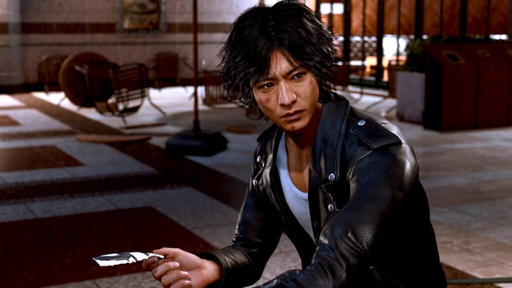 30 Best Games On PS Plus Extra To Play Right Now | | GamesHorizon The protagonist of Lost Judgment picking up a photo from the ground