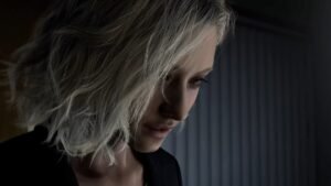 A blonde woman looks down perplexed in Resident Evil Requiem