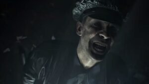 A ghoulish looking police officer smiles and looks to the side in Resident Evil Requiem