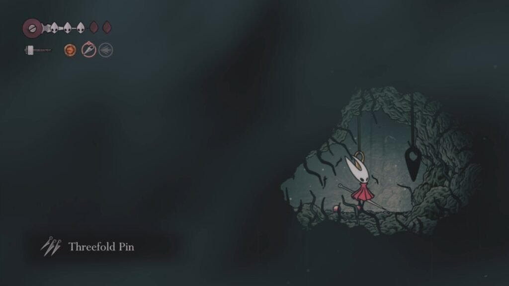 A screenshot showing Hornet picking up Threefold Pin in Hollow Knight SIlksong