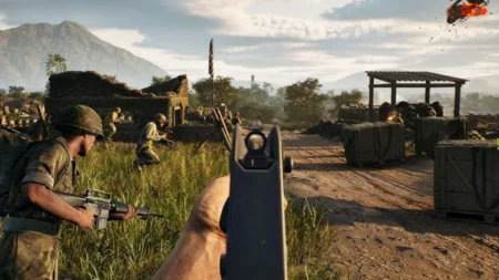 Image of Hell Let Loose Vietnam player aiming down sights of M16 assault rifle with squadmates running in background