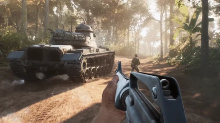 Image of Hell Let Loose Vietnam players standing next to tank moving through jungle