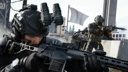 Image of Modern Warfare 4 players aiming down sights of assault rifle. A white objective flag flies in the background