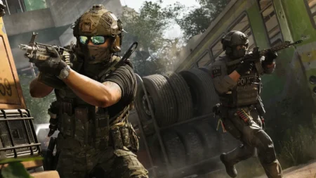 Image of Modern Warfare 4 operators aiming down sights of assault rifle. Large trees are in the background of the operators